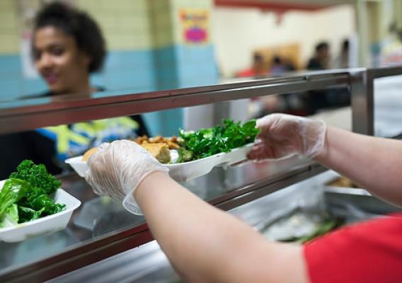 Food service staff at a Delaware high school serving up a local lunch, including kale