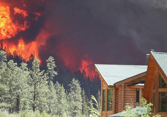 A house threatened by a forest fire in central Oregon