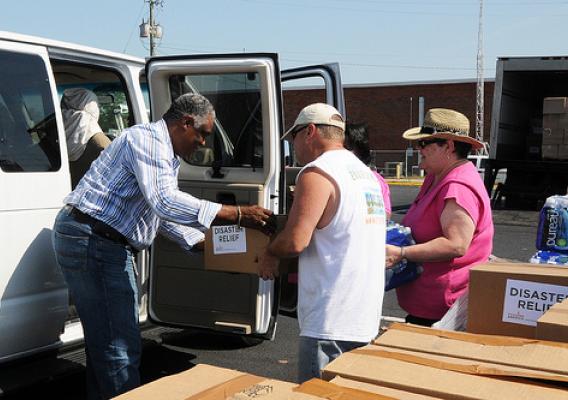 FNS Southeast Regional Administrator Donald Arnette (far left) pitches in with West Alabama Food Bank workers at a make-shift food bank on May 11, handing out disaster food assistance in a Publix parking lot in Tuscaloosa, Ala., after tornadoes hit the area. Food banks can work with FNS to supply food to victims of disasters. USDA Photo by Debbie Smoot.