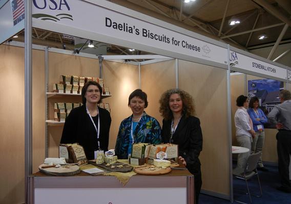 While attending the SIAL Canada international trade show in Toronto on May 13, Foreign Agricultural Service (FAS) Associate Administrator Janet Nuzum (center) met with the companies exhibiting at the USA pavilion including Katherine Bunschoten (left) and Maria Walley (right) of Daelia’s Food Company. Daelia’s is new to the international marketplace and began exporting their products after exhibiting at SIAL Canada in 2010. 