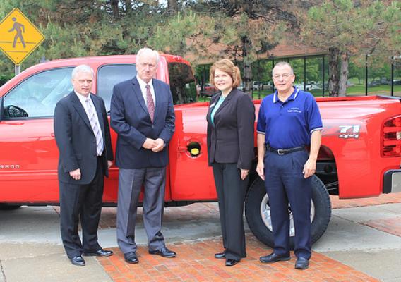 Phil Lehmkuhler, USDA Rural Development Indiana State Director, David Howell, VP Indiana Corn Marketing Council, Judy Canales, and  Nick Kassanos, Assistant Plant Manager of Fort Wayne Assembly, pose in front of a 2011 Flex-Fuel Chevrolet Silverado HD.