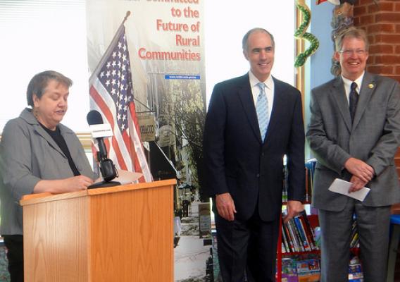 Pittston Memorial Library Director Anne Hogya (left) gives a warm welcome to U.S. Senator Robert Casey (center), and Thomas Williams, USDA Rural Development State Director (right)