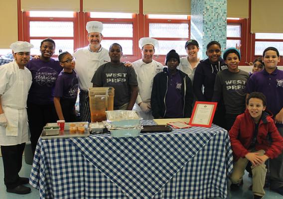 WITS Chef Katie Cook and Chef Partner Henry Rinehart celebrating a WITS Cafe Day (special culinary demo and tasting days) with their students at PS145/West Prep Academy