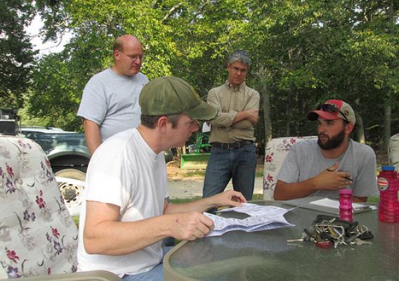 Staff members from the Alliance for the Chesapeake Bay and the Maryland Forest Service advise a forest landowner on options for how to  participate in a water quality trading system.
