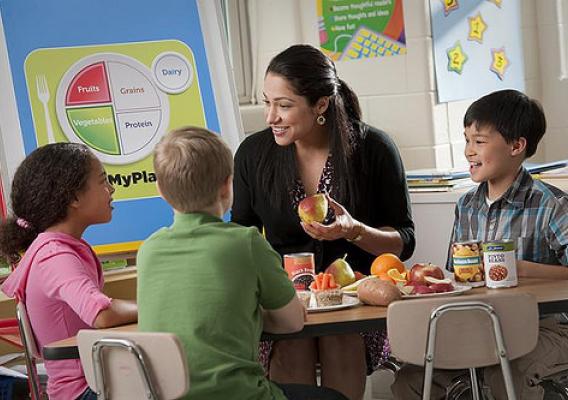 A nutrition educator teaches children about MyPlate