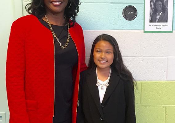 ARS Administrator Dr. Chavonda Jacobs-Young (left) standing with an elementary school student