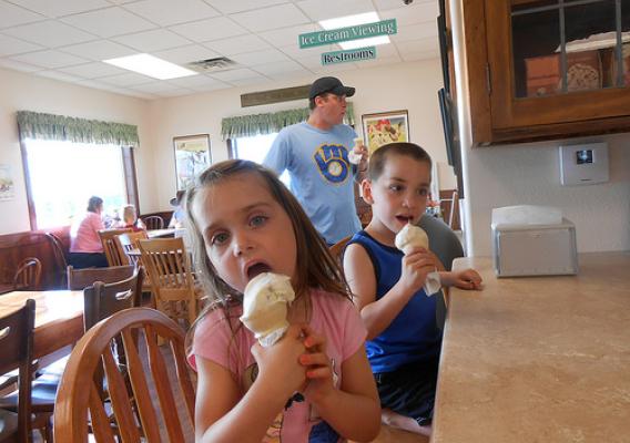 Twins Katrina and Will Edwards, both age 5, and their father Tim dig into ice cream at the Kelley's Country Creamery in Fond du Lac, Wisconsin.  The creamery started operations with assistance from two USDA Value Added Producer grants. USDA photo.
