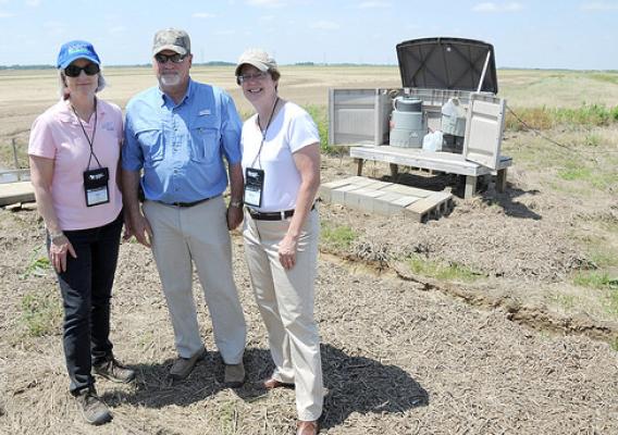 Terry Dabbs gives Ann Mills, USDA Deputy Under Secretary for Natural Resources and Environment, and Nancy Stoner, Environmental Protection Agency Acting Assistant Administrator for Water (right), a tour of his farm. (NRCS photo by Reginald L. Jackson)