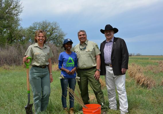 A recent tree planting and habitat restoration service project at the Rocky Mountain Arsenal Wildlife Refuge was part of activities to announce $6.7 million in grants to support conservation employment and mentoring opportunities for youth on public lands. From left, Erin Connelly, Forest Supervisor of the Pike and San Isabel National Forest and Cimarron and Comanche National Grasslands; Agnes Mukagasana a youth from Groundwork Denver; Daniel Jirón a regional forester with the U.S. Forest Service; and USDA 