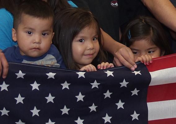 Reyanna Nastarcio’s grandchildren hold the American flag that was presented to her by Rural Development Housing Administrator Tony Hernandez and State Director Terry Brunner.