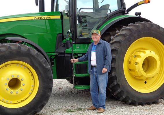 Farmer Wayne Erickson, now 83, and his current tractor. (NRCS photo)