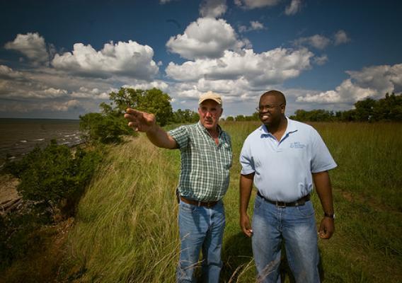 A district conservationist with NRCS (right) works with a Maryland farmer to discuss conservation options for his farm that include improving water quality in the Chesapeake watershed. NRCS photo.