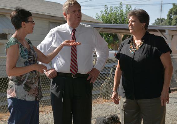 Carlen Overby (left), with Agriculture Secretary Tom Vilsack and Rural Development State Director Glenda Humiston, shares some of the struggles she and her neighbors in Cameron Creek Colony face since their wells have gone dry.