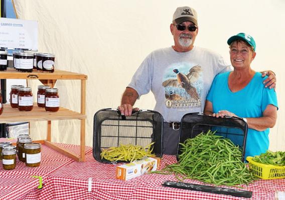 Ernie and Terry Lehmkuhl of Springerridge Barnyard Products, organizers of the Country Farmer's Market in Pierre, SD, show off their products at a recent market.