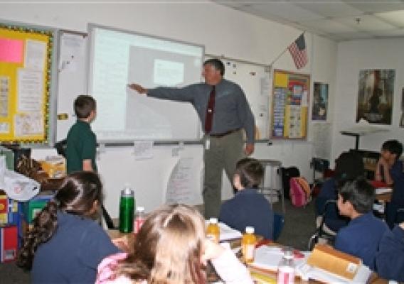 Fifth Grade teacher Doug Schoemer instructs his students about their Google Earth assignment.