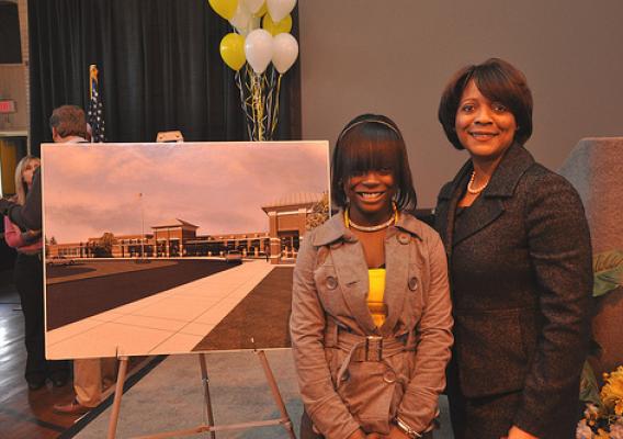 Former Dillon School student Ty'Sheoma Bethea, (L) who wrote a letter about the condition of her school to  President Obama, stands with Rural Development South Carolina State Director Vernita Dore next to a drawing of a new school building funded with Recovery Act loan and grant funds provided through USDA. 