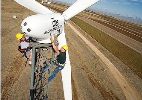 80 feet above ARS’s Bushland, Texas, research station, agricultural engineer Byron Neal (right), of ARS, and mechanical engineer Adam Holman, of the Alternative Energy Institute, West Texas A&amp;M University, perform quarterly service on a wind turbine.