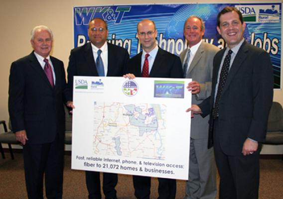 Federal, state and local officials display a map that highlights the coverage areas in which expanded and improved broadband service will be offered. They include (from left) Tom Fern, State Director for Rural Development (Ky.), Trevor Bonnstetter, CEO of WK&T, RUS Administrator Jonathan Adelstein, Bobby Goode, State Director for Rural Development (Tenn.), and Jonathan Miller, Ky. Finance Cabinet Secretary.