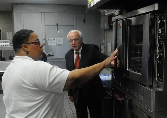 Jerrisa Carter shows Under Secretary Kevin Concannon new equipment purchased with ARRA funds. 