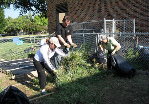 SWR FNS employees (left to right) Patricia Mancha, Edward Mekeel and Lupe Gomez clear out gardening plots in B.H. Macon Elementary School’s People’s Garden.