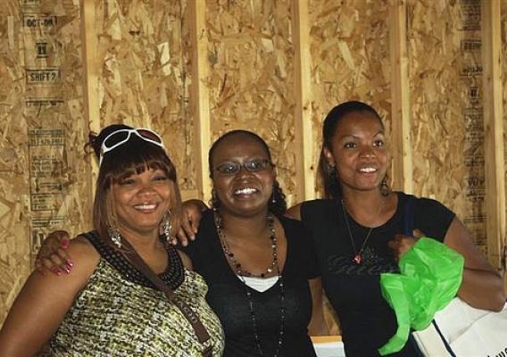 (From left) Carol Daniel, Jessica Jackson, housing counselor for YouthBuild McLean County and Natalie Powers are all smiles as Daniel and Powers begin moving into their new “green” homes in Carlock, Ill.