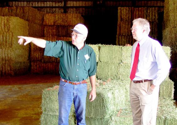 Farmer  David Fink (left), owner of Heidel Hollow Farms shows State Director Tom Williams, how Rural Energy for America Funding will help reduce his farm’s energy costs.  