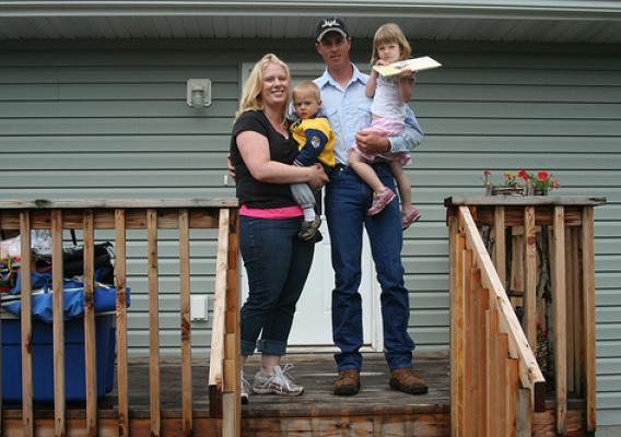 Ted and Kellie baker standing on the deck of their new home.  