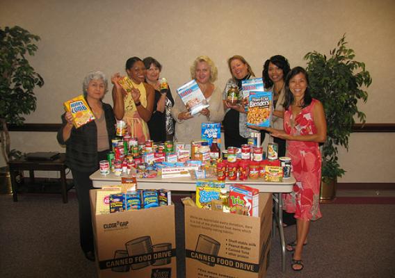 Lupe Gomez, Coordinator and WIC staff show their contributions to the food drive.