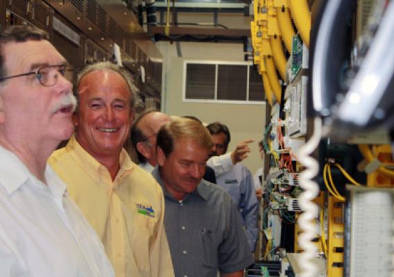 Fentress County Mayor John Mullinix, RD State Director Bobby Goode, and Clay County Mayor Dale Reagan view Twin Lakes telephone Co-op's main switching facility in Jamestown.