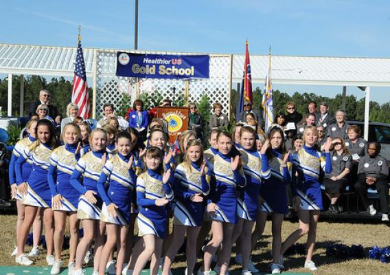 Sixth Grade cheerleaders from Sumrall Middle School perform a “healthy eating” cheer during a HealthierUS School Challenge awards ceremony where their school received a Gold level award from USDA FNCS Deputy Under Secretary Dr. Janey Thornton.  