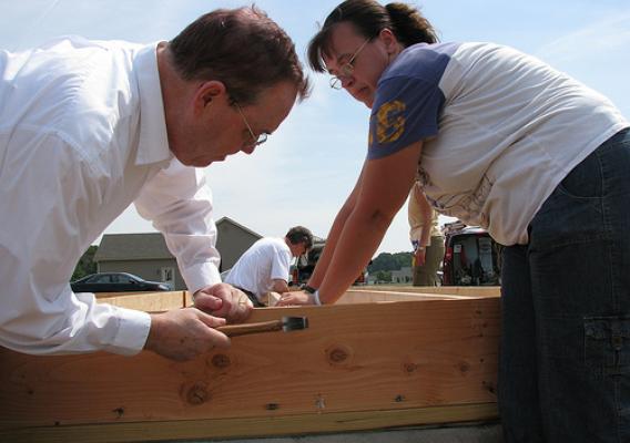 Agriculture Under Secretary for Rural Development Dallas Tonsager helps prospective homeowner Suzanne Passwaters construct floor joists at a USDA Self Help Housing site on the DelMarVa Peninsula.   