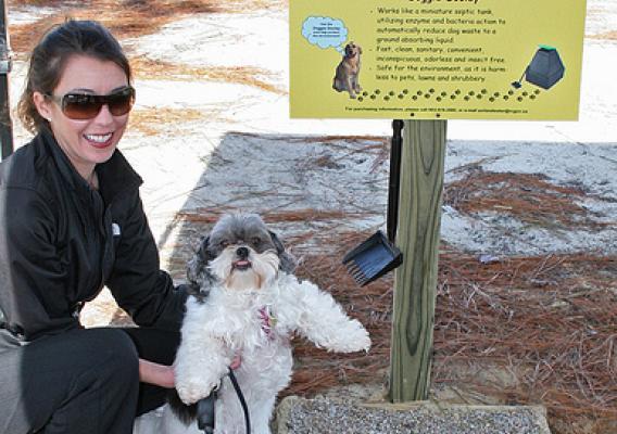 Elizabeth Brown and her dog Jane check out the pet waste disposal system at a park in Richland County, South Carolina. 