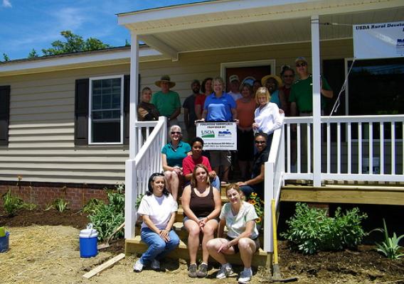 Second step from bottom (center) is Ms. Brandy Russell the Homeowner. Surrounding her are all of the Rural Development Staff that helped with the final landscaping and construction duties during the Volunteer Day held June 15th...