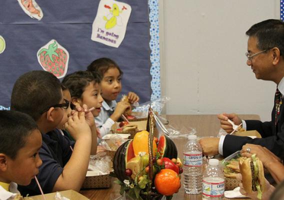Allen Ng (right), Regional Administrator for Food and Nutrition Service, is having lunch with Columbia School students.