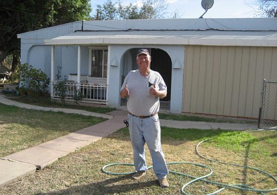 Larry Bagby in front of his home.  His house now has a safe sanitation system thanks to the Recovery Act and USDA.