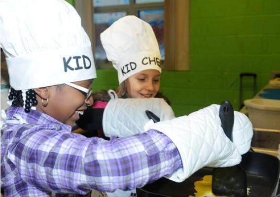 Tanyah Ramos and Caylie Bain scramble eggs in the first step of a healthy fried rice recipe they are learning through the KID CHEF program sponsored by the Food Bank of Delaware.