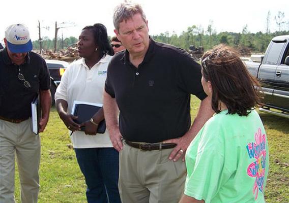 Secretary Tom Vilsack toured the area of Smithville, Mississippi and saw firsthand the heavy damage caused by the tornado. He is seen in this photo talking to one of the victims of the disastrous weather. Behind him is USDA Rural Development State Director Trina George of Mississippi. Secretary Vilsack and State Director George were two of a number of Obama Administration Cabinet officials, federal administrators, and local leaders to see the damage caused by tornadoes in Mississippi and Alabama.