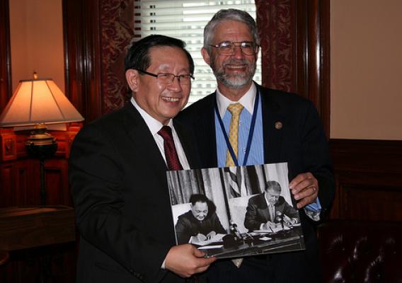OSTP Director John P. Holdren and the Minister of Science and Technology for the People’s Republic of China Wan Gang hold a photograph of U.S. President Jimmy Carter and Chinese Premier Deng Xiaoping signing the original U.S.-China Agreement on Cooperation in Science and Technology in 1979.