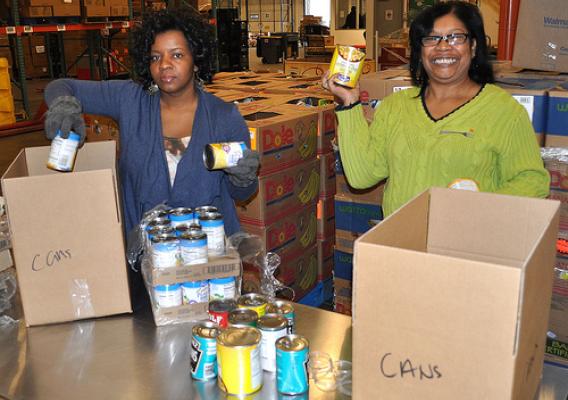 Southwest Region SNAP staffers Katrina Kamau and Vernzel Mosby-Byrd  box canned goods during a volunteer evolution at the North Texas Food Bank in Dallas. The North Texas Food Bank provided access to over 45 million meals in 2010.  