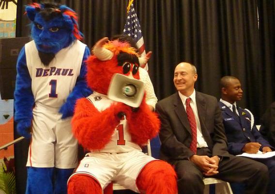 Midwest Deputy Regional Administrator Tim English leads a cheer with DePaul Blue Demons mascot DIBS and Chicago Bulls mascot Benny.
