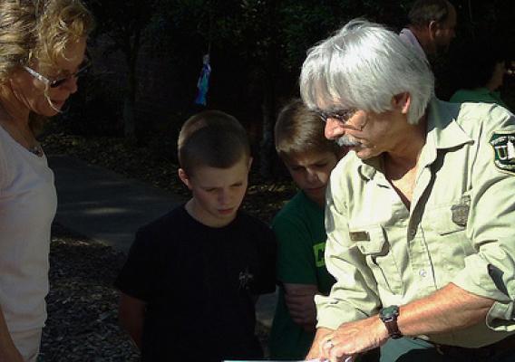 U.S. Forest Service Southern Region Endangered Species Specialist Dennis Krusac talks pollination with Mary Kalafut, her son Michael (left) and Edward Lynch at Ford Elementary School’s recent Evening in the Garden event. 