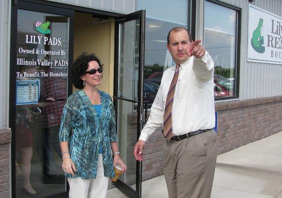 John McCormick, III, Senior Vice President of Hometown National Bank in LaSalle, points Deputy Under Secretary Kunesh toward the Illinois Valley PADS Homeless Shelter in Peru. All proceeds from Lily PADS Resale Boutique are provided to the shelter. USDA photo.