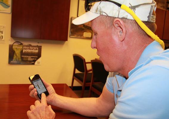 Keith Johnson checks the latest from NRCS Minnesota and the other people and groups he follows on Twitter on his phone. 