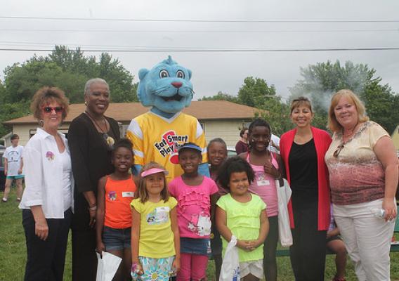 Rowe with kids and the Power Panther at the PowerHouse Ministries site in Marshall, MO.