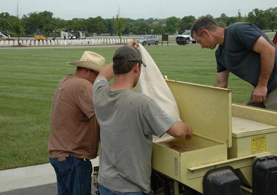 NRCS Soil Conservationist Allen Casey, Biological Technician Nick Adams and Plant Materials Center Manager Ron Cordsiemon select a blend of warm season grass seed for both drill and broadcast into the field at Jefferson Barracks National Cemetery. NRCS photo.