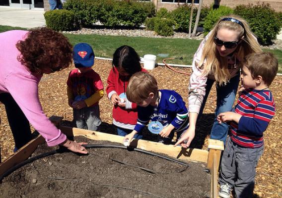 From left to right: Nevada NRCS employee Consuelo Navar, Supply Clerk, helps preschoolers from One World Children’s Academy plant seeds in the People’s Garden, along with a parent helper. Photo by One World Children’s Academy.