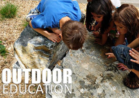 Children from Warren Village discover hiding spots for bugs at Warren Village’s new Nature Explore Outdoor Classroom in Denver. (Courtesy of Dexter Lane, Nature Explore)