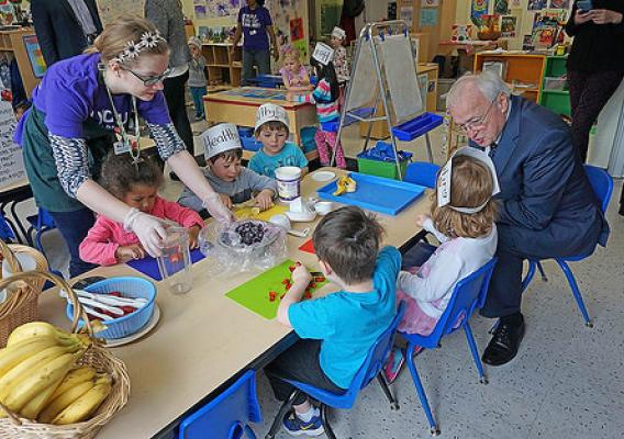 USDA Undersecretary of Food, Nutrition, and Consumer Services Kevin Concannon participating in a hands-on lesson about local foods at a YMCA preschool in West Seattle, WA