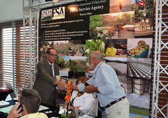 Juan Ortiz Servia, State Executive Director for the USDA Farm Service Agency, greets a local farmer at the Market Expansion Conference held June 22 & 23 in San Juan, Puerto Rico.