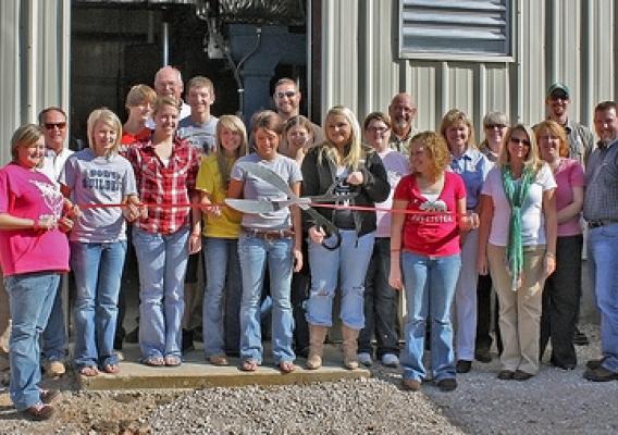 Students, speakers, and honored guests cut the ribbon at Southern Reynolds County R-II School Districts wood chip fired heating plant. USFS photo.